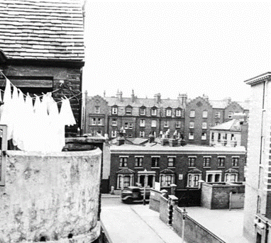 Victory Place Late 1950's. Looking across Rodney Road (Where the truck is) to the Guinness Buildings in Brandon Street. Victory primary school is on the right. X.png