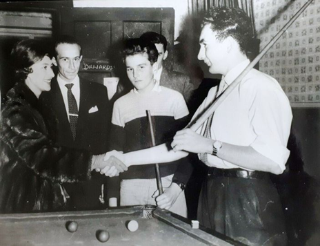 Eugenia Road, Bermondsey 1959, Billiards room 4Y's Club. Princess Margaret, club leader Sydney Jones (With the cue on his shoulder) and 17-year-old club member John Regan next to him. X.png