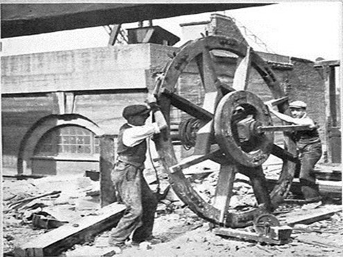 Rotherhithe, c1930. This 8ft wooden wheel part of the first cranes use by the Port of London Authority, is said to be three centuries old.  X..jpg