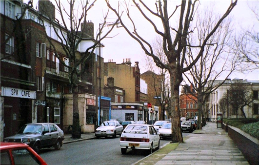 Spa Road. The Spa Cafe & Hairport & Studio V2 Plus hairdressers with flats above, c.1990.    X..png