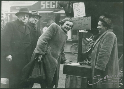 Southwark Park Road. In this photo from 1950, we can see a stallholder gathering signatures for a petition to Bermondsey Borough Council.  X..png