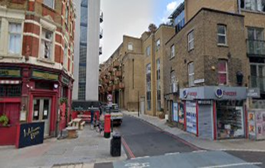Tooley Street 2021, looking down Three Oak Lane. In c1921 there was an Oil Merchant shop on the corner right, now an Off Licence. X..png