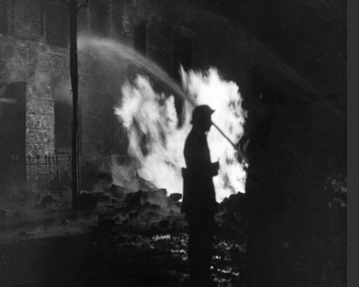 Long Lane, Bermondsey, March 1941. Blitz in London -- firefighters at work with hosepipes at a burning gas main.   X (2).png