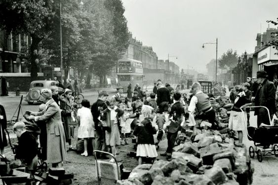 Camberwell Road c1952, looking towards Camberwell Green, collecting the dug-up tarry blocks.   X..png
