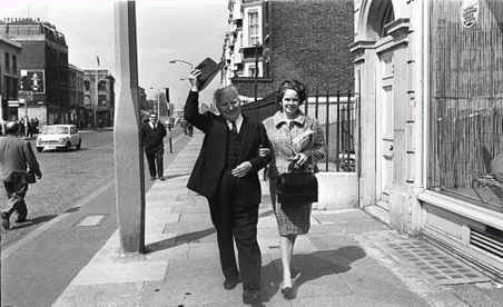 Old Kent Road, Charlie Chaplin and his wife outside Edgington’s snooker tables show room.   X.png