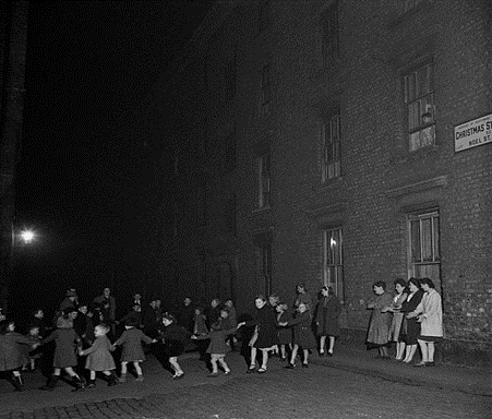 Christmas Street, formerly Noel Street, Children dancing in the street, December 1946.  X..png