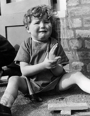Kintore Way, Bermondsey, c1939, a tearful little boy at the nursery school has hit his thumb with a hammer.   X..png