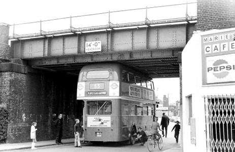 Hornshay Street, Off Old Kent Road, number 53 bus jammed under rail bridge after taking the wrong turning. Ilderton Road in background with Tustin Estate being constructed,1968.   X..jpg