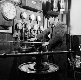 Tower Bridge. A Port of London official controls the hydraulic engines which operate the bascules of the Bridge.  X..jpg