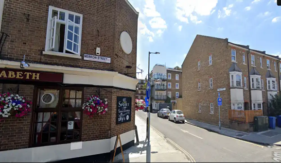 Merrow Street, looking down Lytham Street, 2022. The Queen Elizabeth Pub left; Hewitt's Newsagents was on the corner right.  X..png
