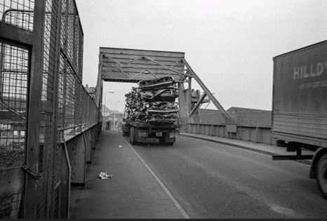 Redriff Road, A lorry carrying scrap metal goes over the lift bridge. X..png