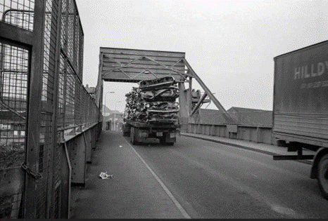 Redriff Road, A lorry carrying scrap metal goes over the lift bridge.  X..png