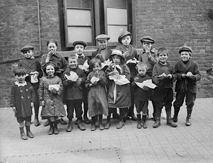 Children eating a penny's worth of Plum Duff (a rich, spiced suet pudding made with raisins or currants) from soup kitchens in Bermondsey, South London, c1917. My mum made this. X..png