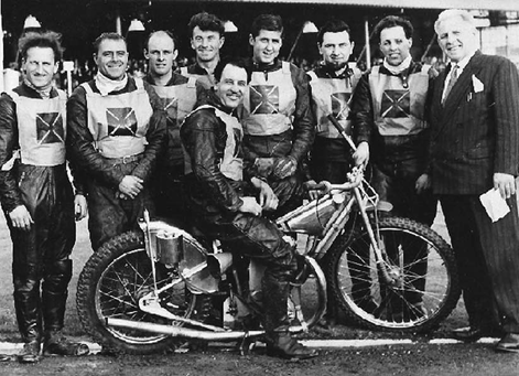 Hornshay Street, left to right, Jimmy Gooch, Eric Williams, Leo McAuliffe, Reg Luckhurst, Split Waterman on bike, Barry Briggs, Tom Sweetman, Bobby Croombs, Johnnie Hoskins(promoter). 1 X..png