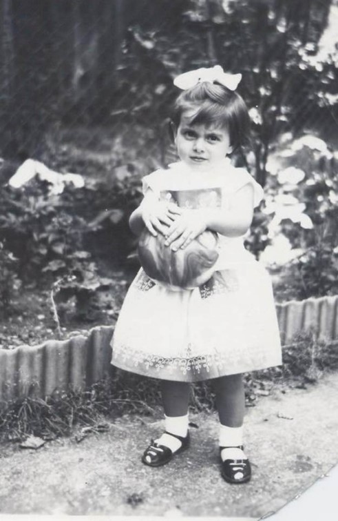 Jamaica Road. Bermondsey Irene Waters in her Pops Garden, holding football.  X..jpg