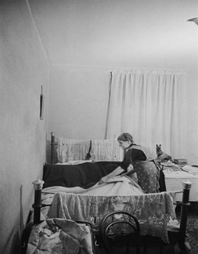 Christmas Street, a pensioner makes her bed at home in Christmas Street, December 1946.  X..jpg