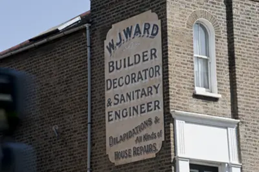 Trafalgar Avenue, 2015. W J Ward, Builder, Decorator & Sanitary Engineer on the north wall of number 49.  X..png