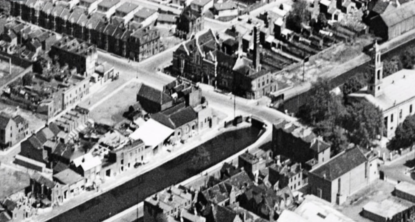 Wells Way Bridge with Grand Surrey Canal, c1946.  St Georges Church, Passmore Edwards Library, Baths and Wash House. Harling Street left, opposite Neate Street.  X..jpg