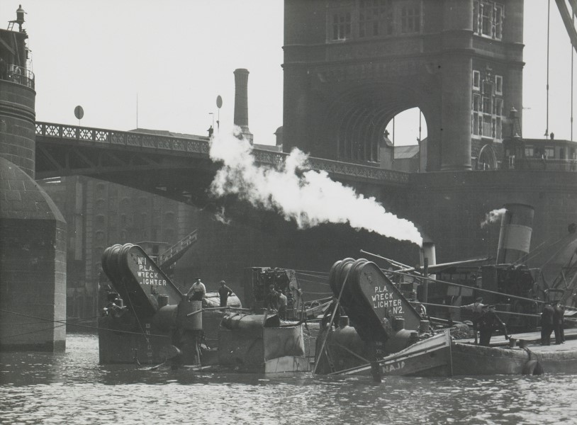 City bomb damage, wreck lighters raising the tug 'Naga', Tower Bridge, 12th July 1944  X.jpg