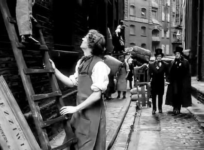 Film Scrooge 1951. Cathedral Street SE1 with St. Mary Overy's Wharf in the background.A young Ebenezer Scrooge George Cole and Jacob Marley Patrick Macnee approach their newly acquired pr.jpg