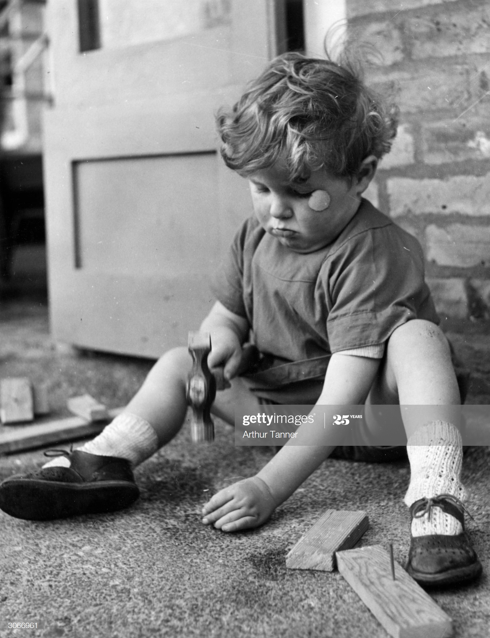 Grange Road, Kintore Way, Bermondsey, 1936. A little boy plays with hammer and nails at the nursery school.  X.png